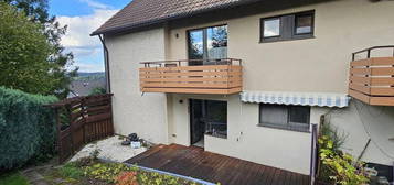 Elegante Erdgeschosswohnung mit Terrasse, Gartenblick, Balkon und zwei Bädern mit Fenster.