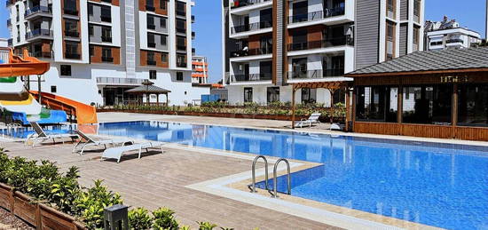 SIFIR GÜVENLİKLİ SİTEDE AQUA PARKLI ,KAPALI OTOPARKLI LÜX 1+1